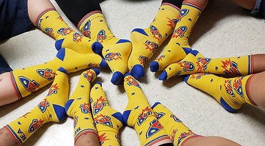 Students wearing matching Beyond Expectations Academy rocket socks